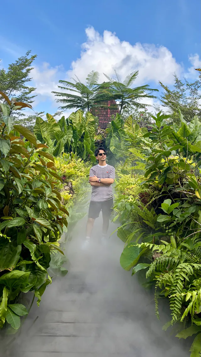 Ramy standing in a tropical garden in Bali