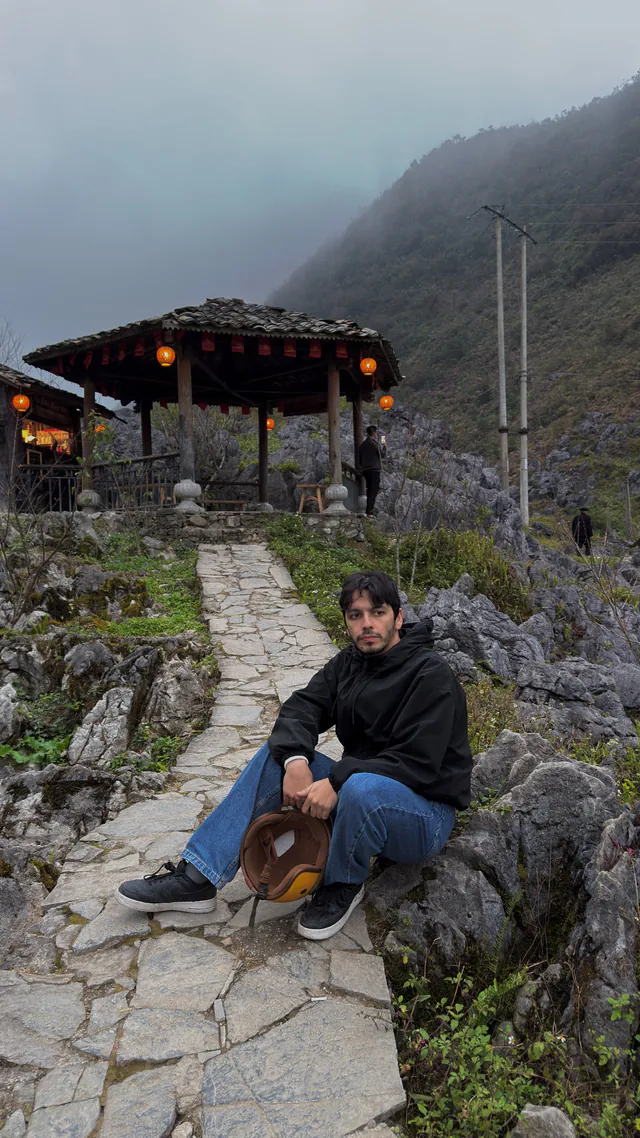 Ramy sitting on a mountain path in Vietnam